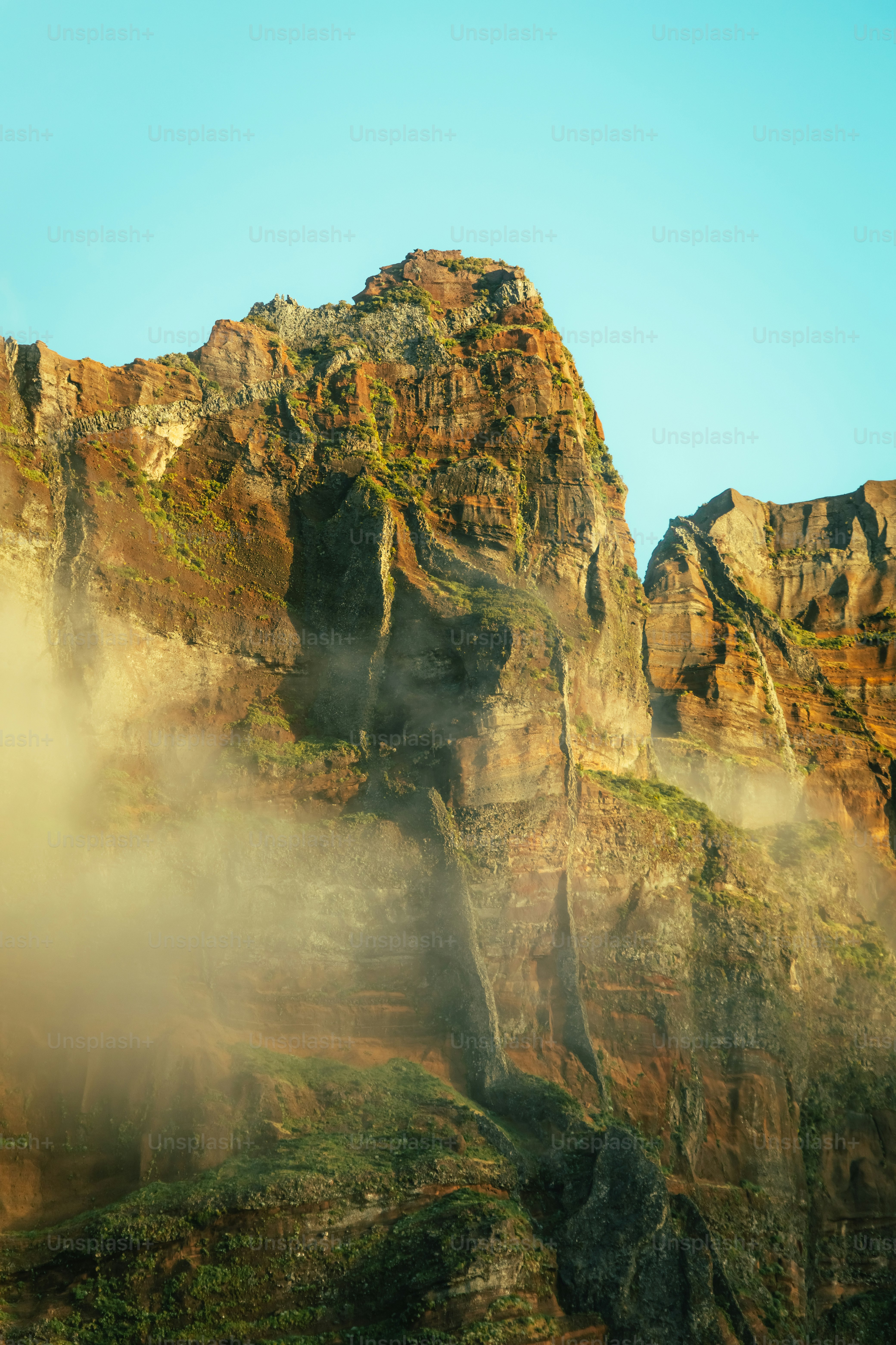 a very tall mountain with some very pretty clouds