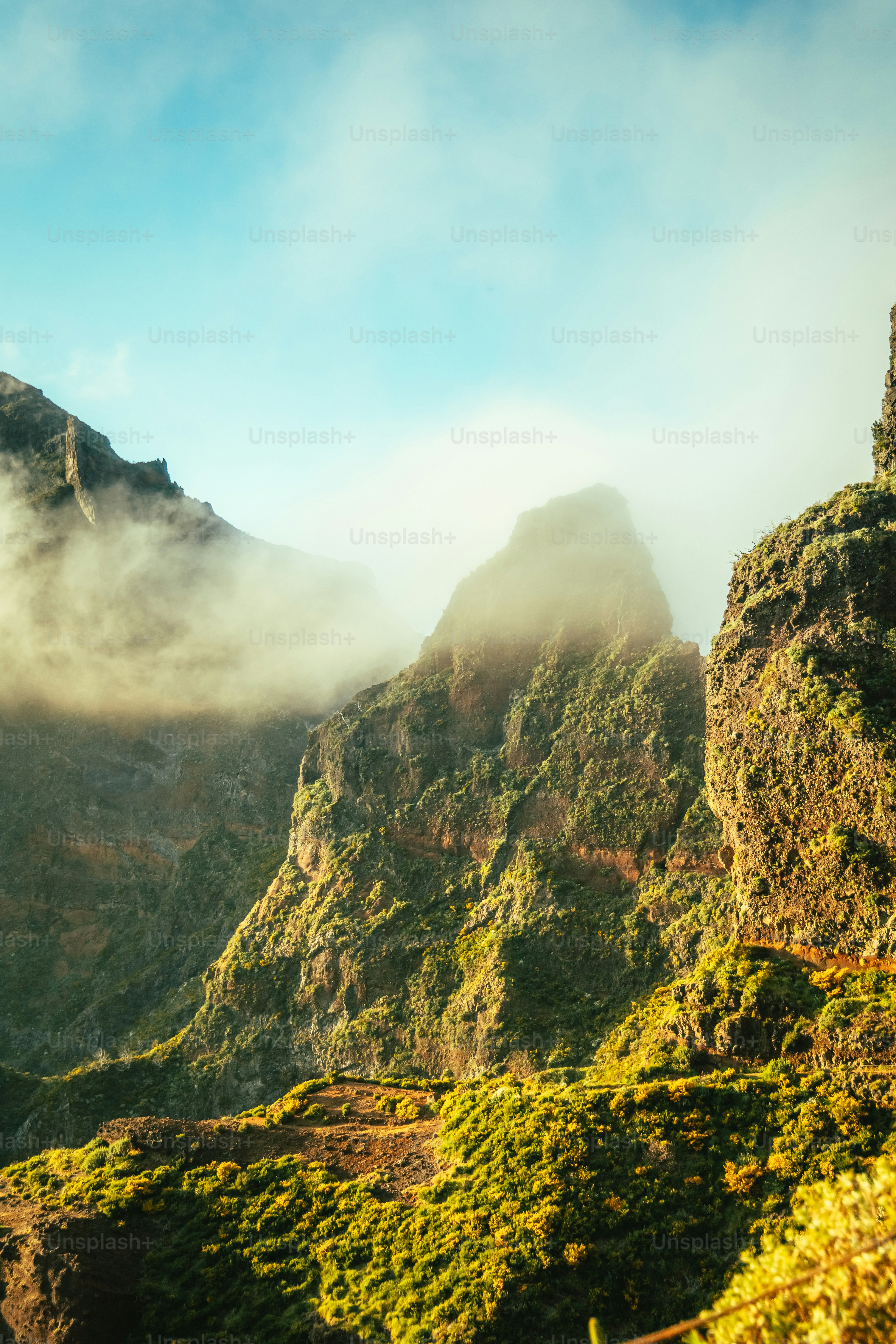 a view of a mountain with a cloud in the sky