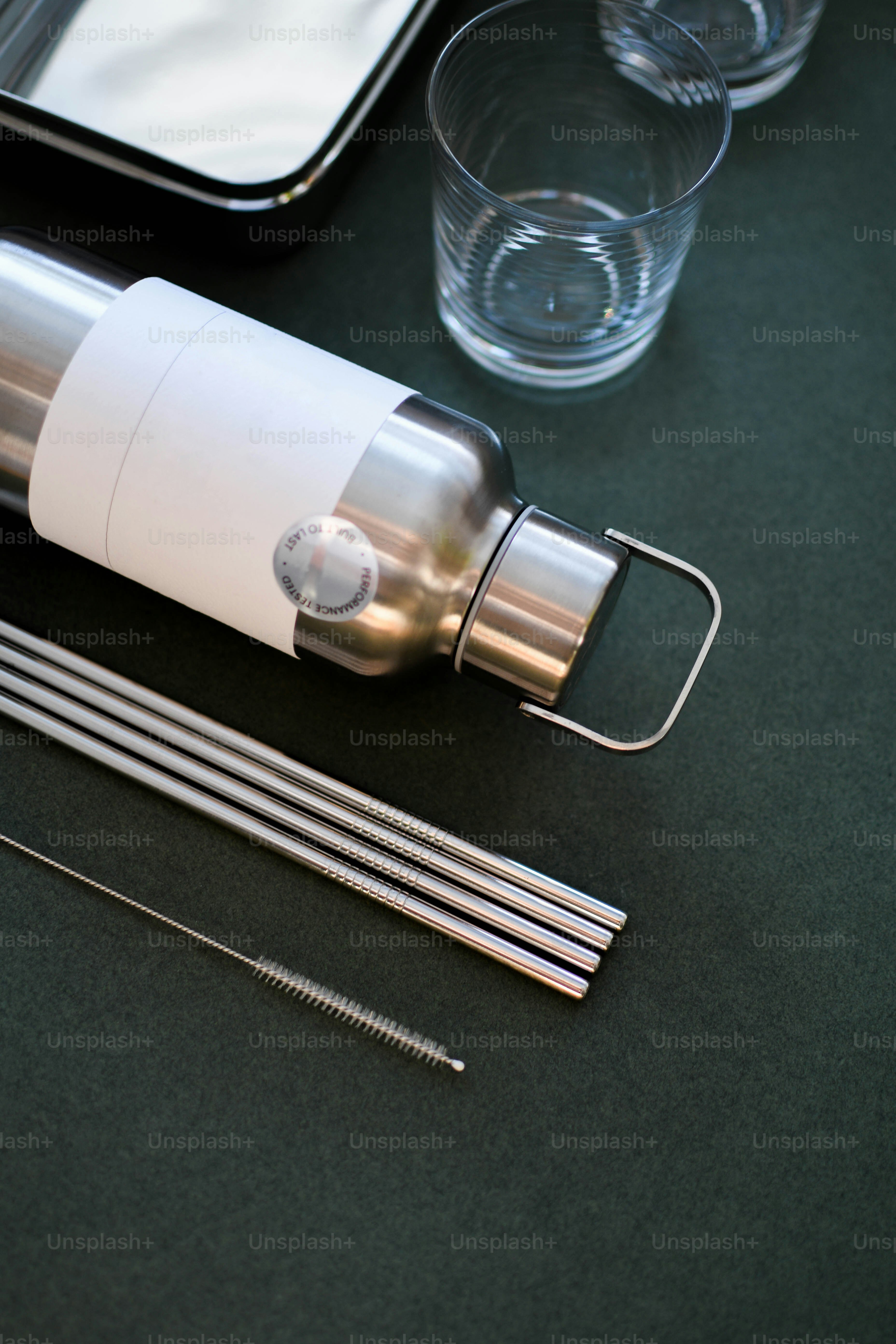 a table topped with glasses and a bottle of water