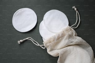 a white bag with a white face mask on it