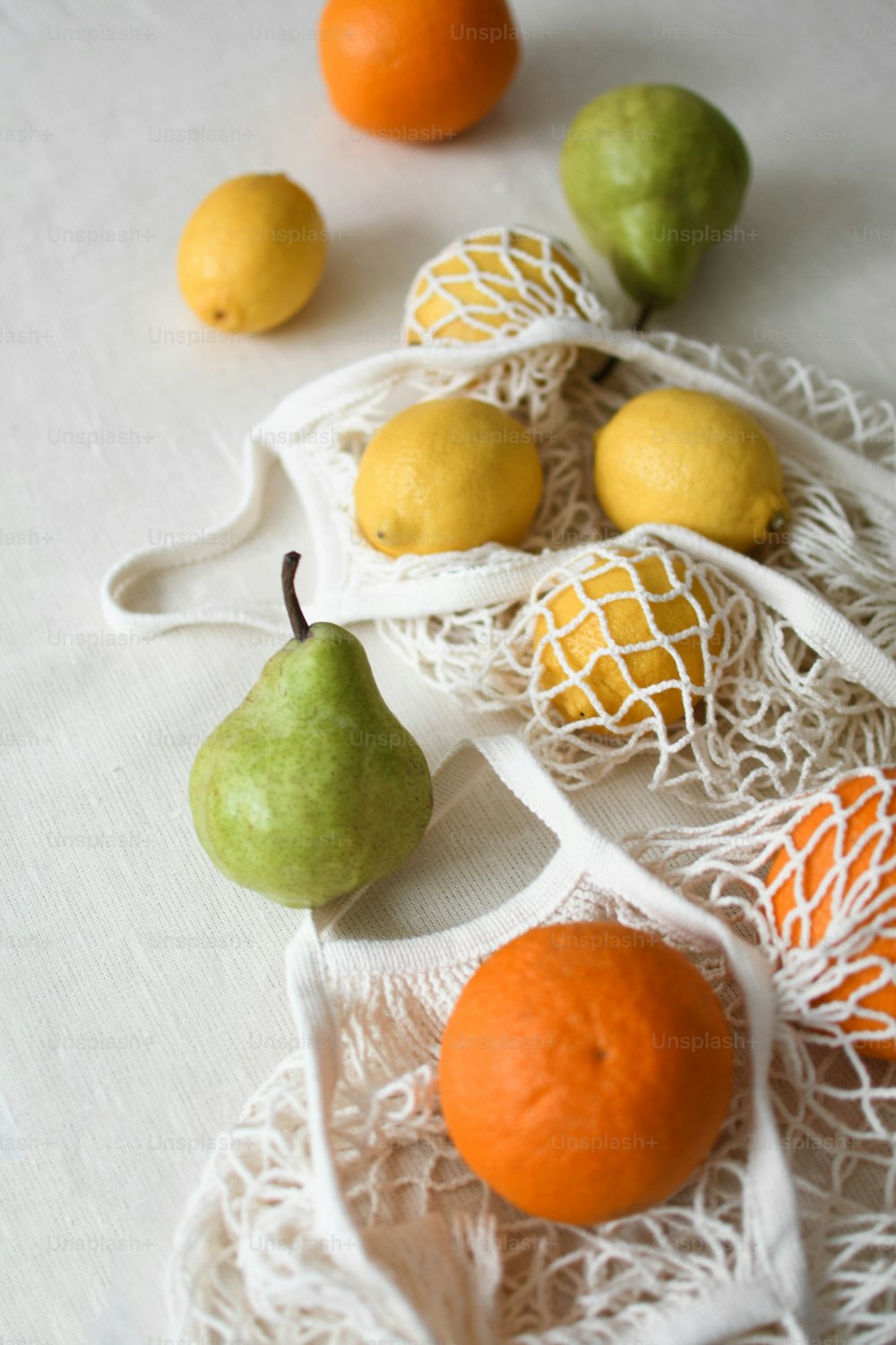 a white bag filled with fruit on top of a table