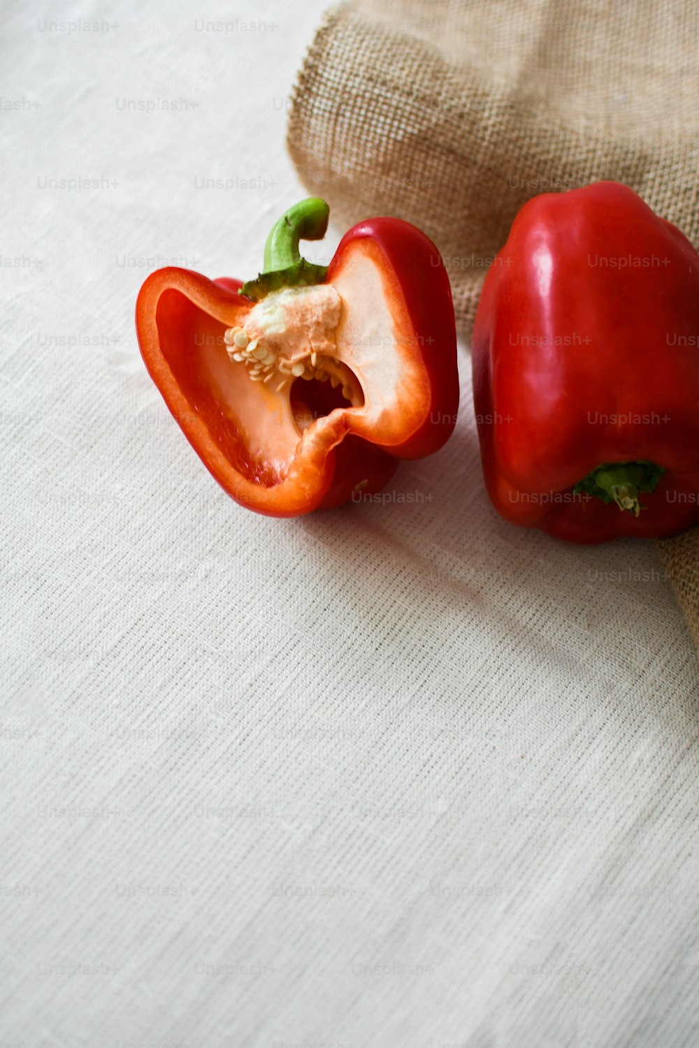 a couple of red peppers sitting on top of a table