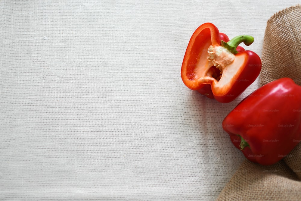 a couple of red peppers sitting on top of a table