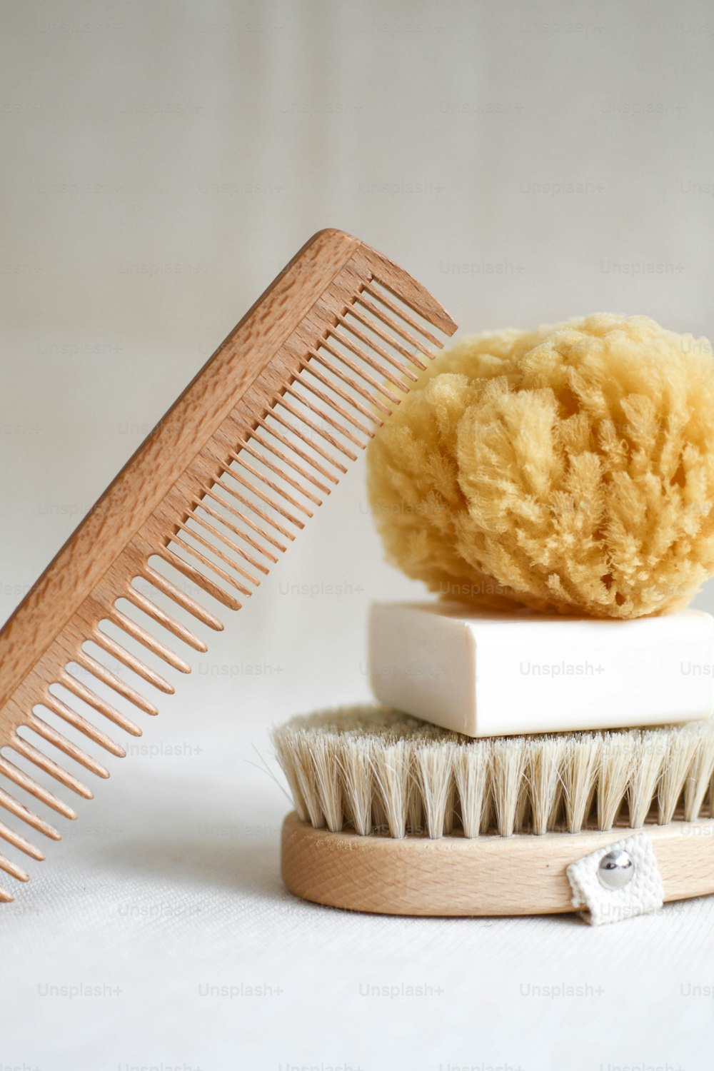 a comb and a sponge sitting on top of each other