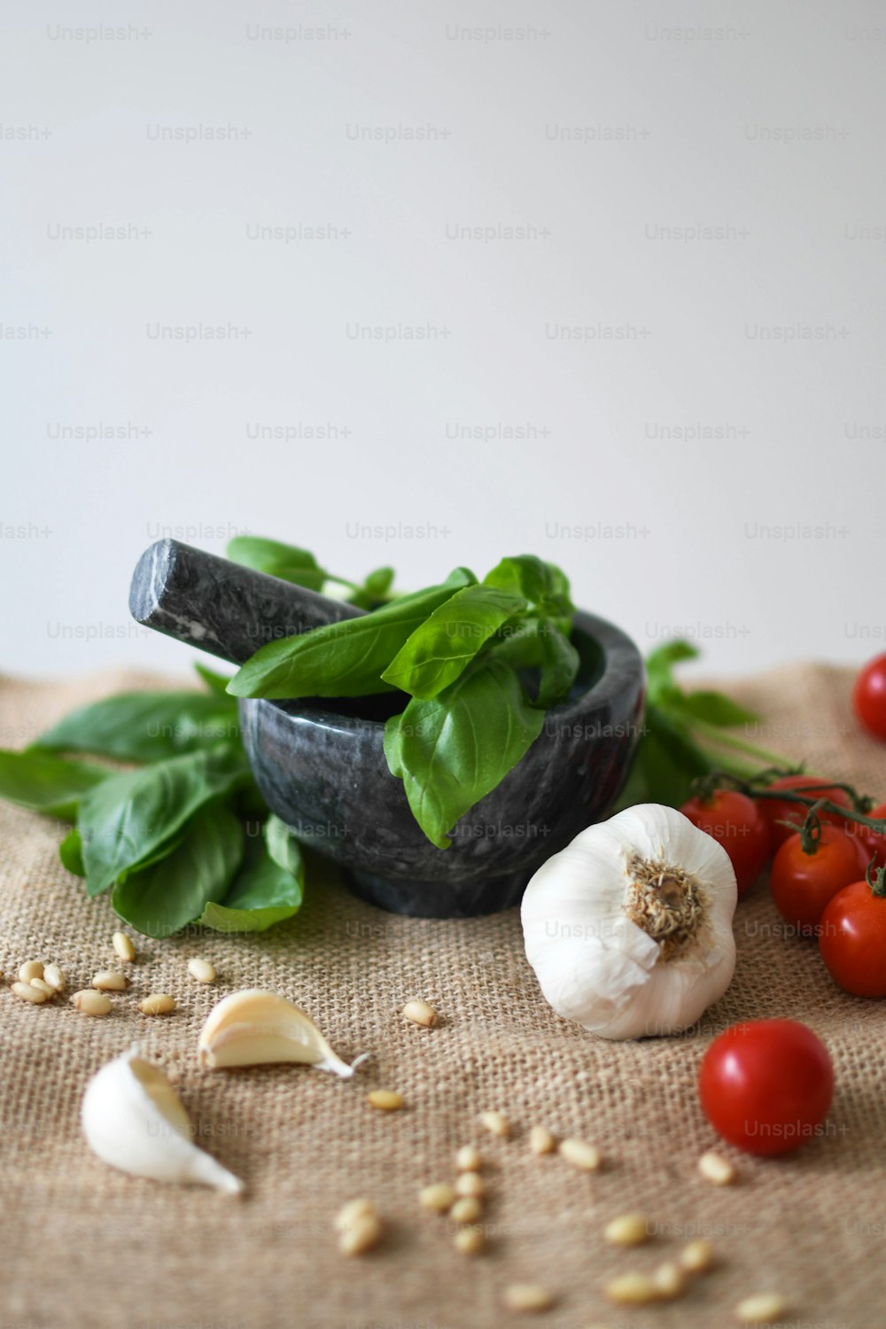 a bowl of spinach, garlic, tomatoes, and garlic on a table