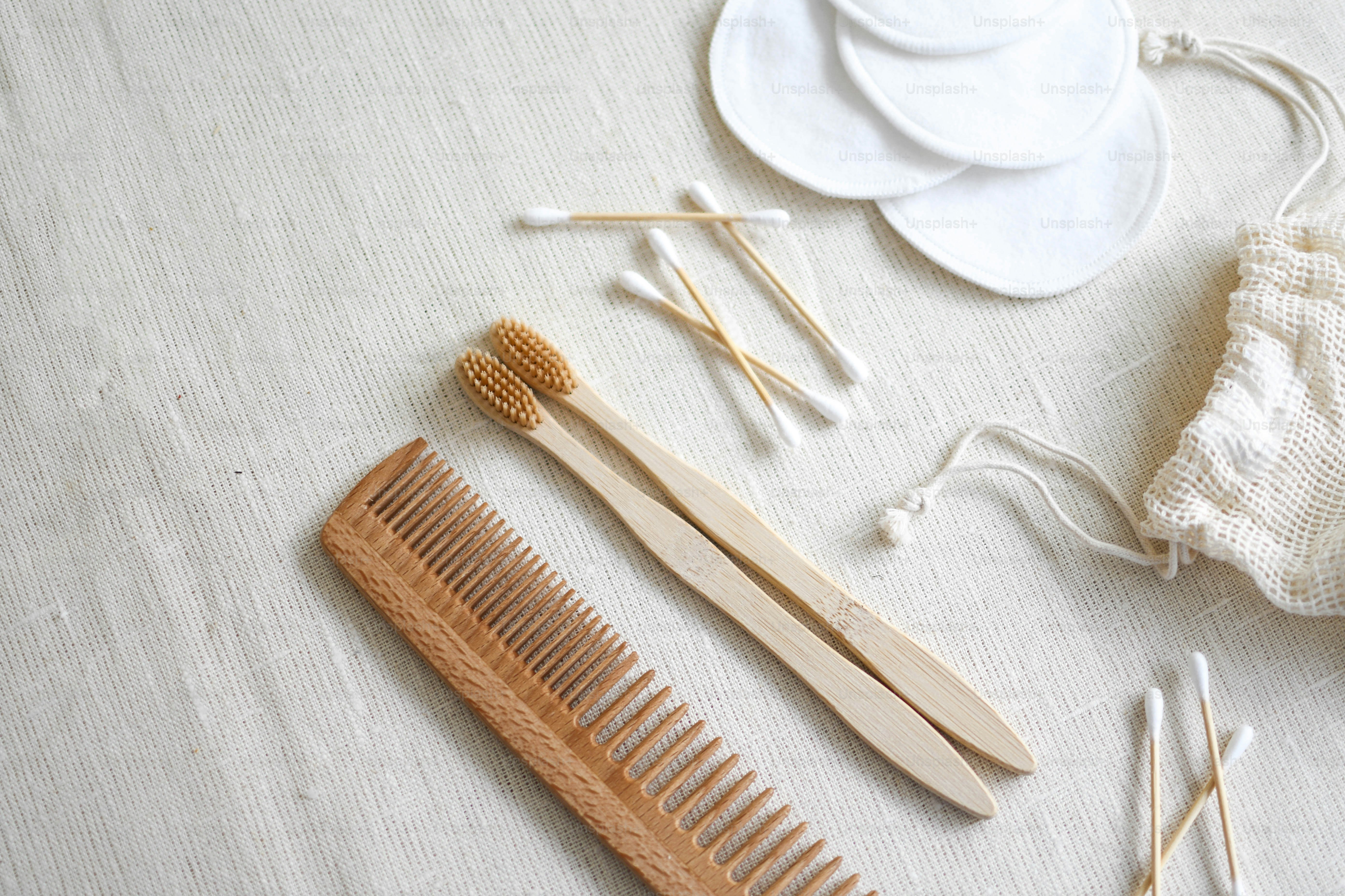 a couple of wooden combs sitting on top of a table