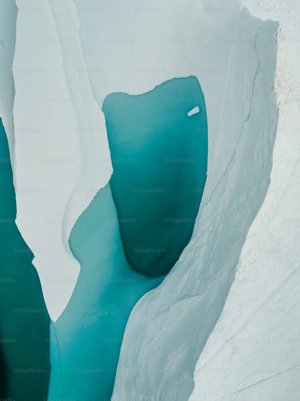 a man riding skis down the side of a snow covered slope