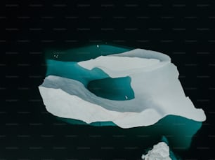 an aerial view of an iceberg in the water