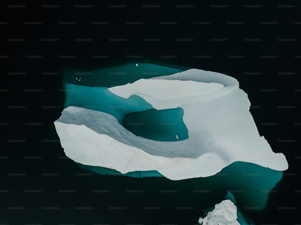 an aerial view of an iceberg in the water