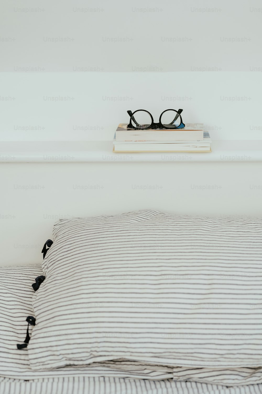 a pair of glasses sitting on top of a bed