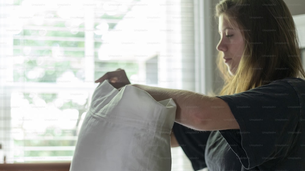 a woman holding a white bag in her hands