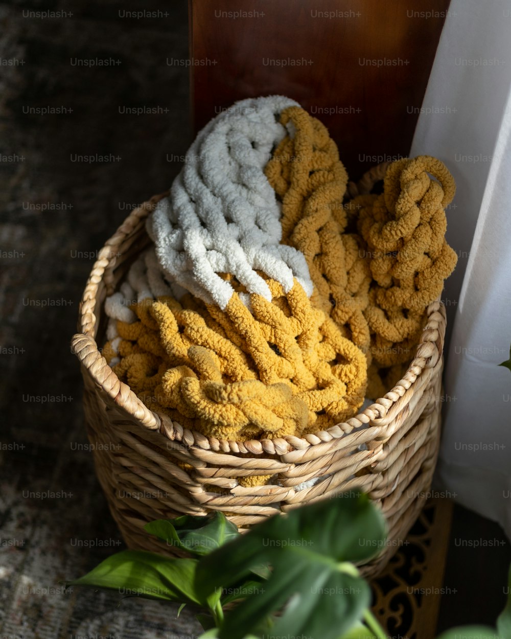 a basket filled with yellow and white towels