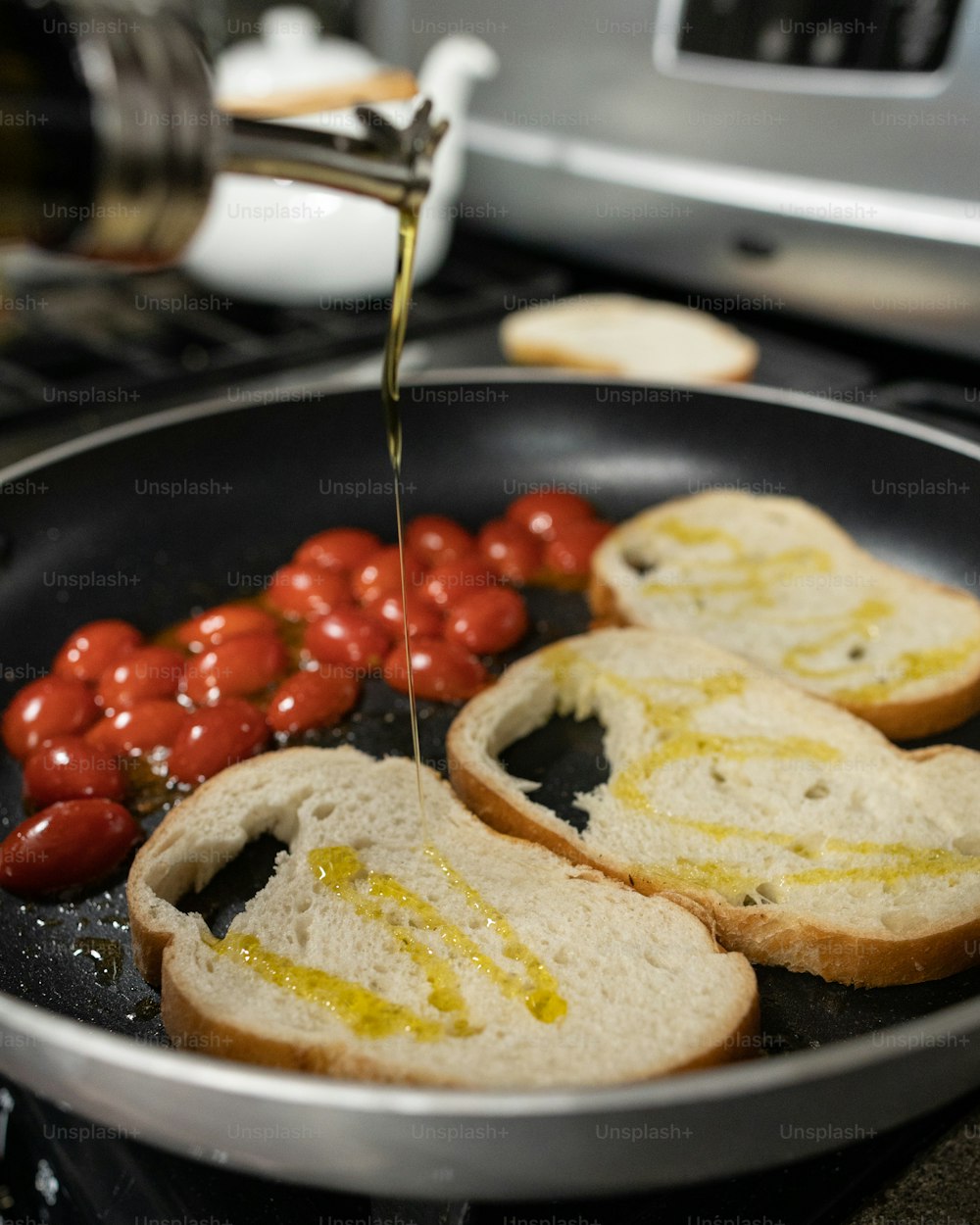 a frying pan filled with bread and tomatoes