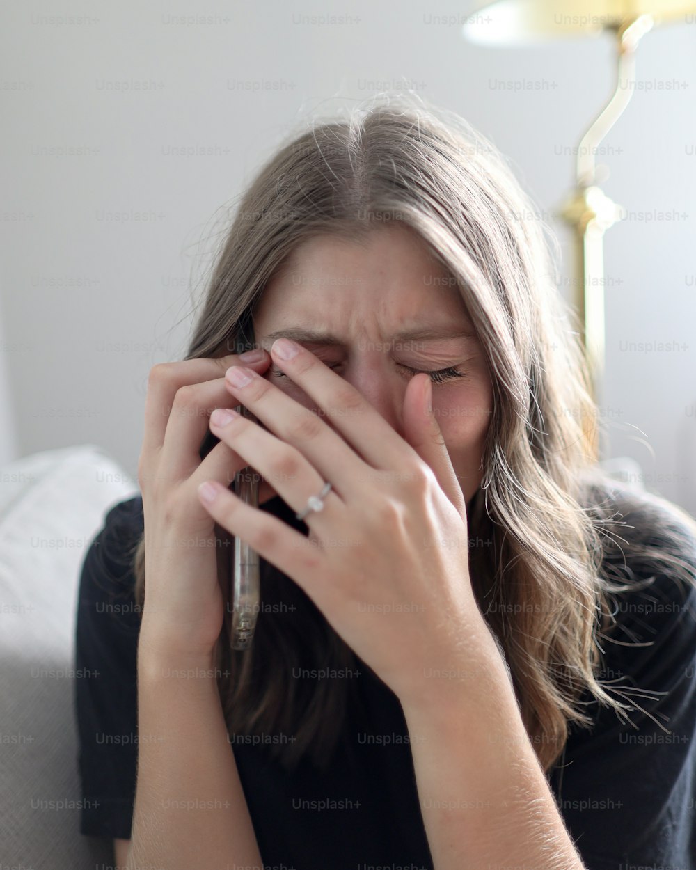 a woman covers her face with her hands