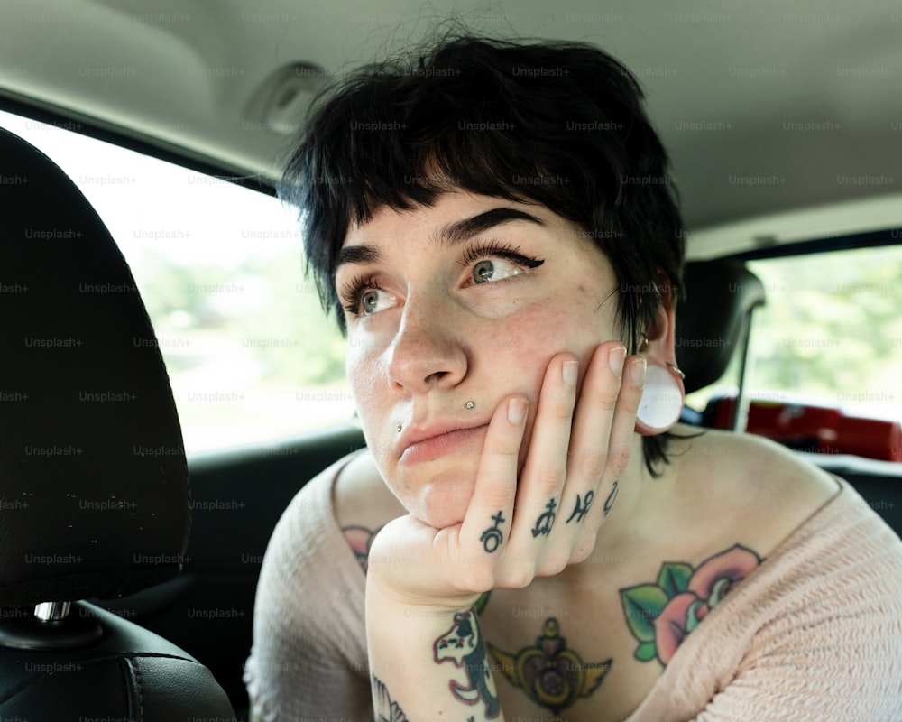 a woman sitting in the back seat of a car