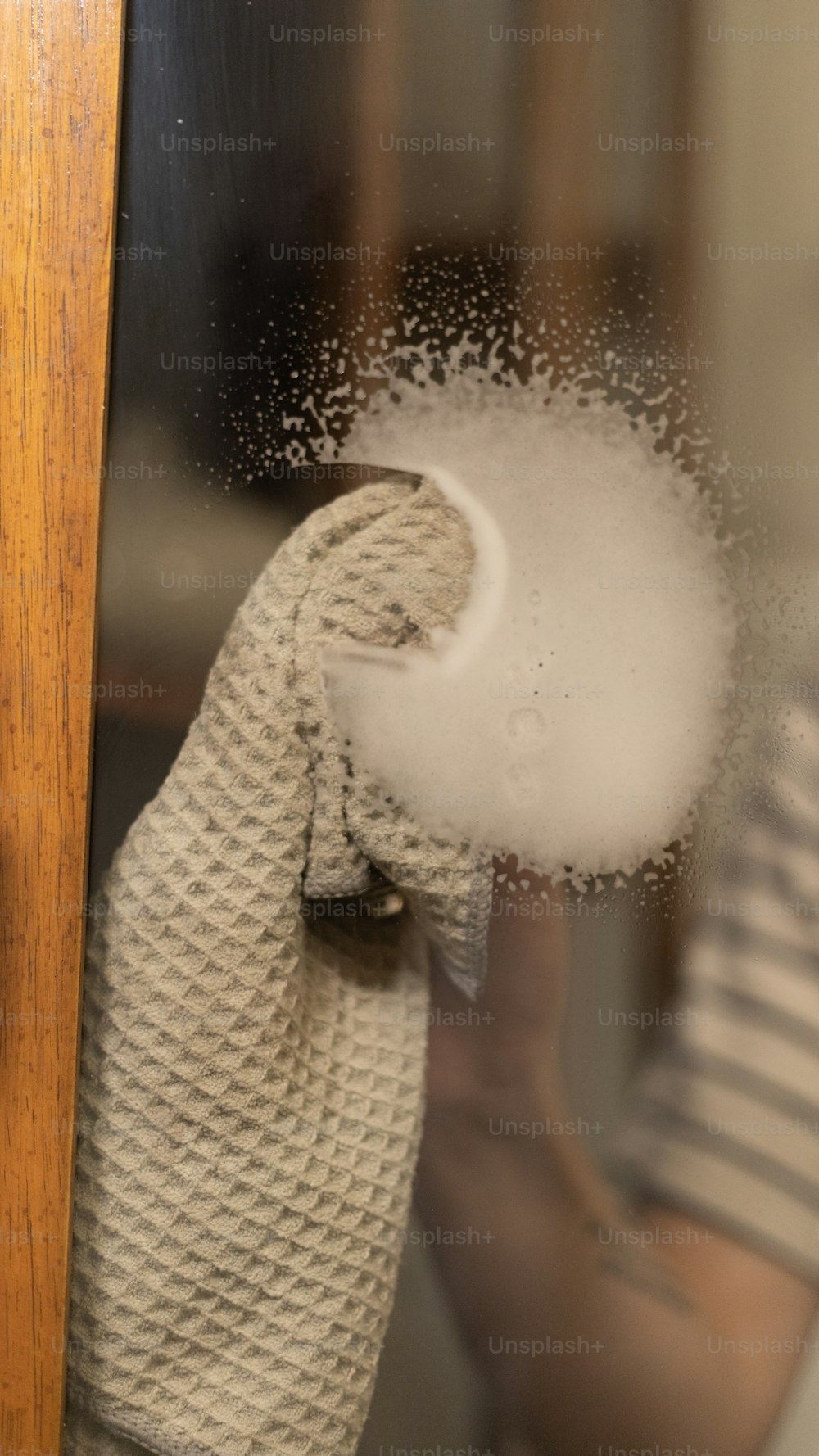 a hand is holding a cloth with a lot of white powder on it