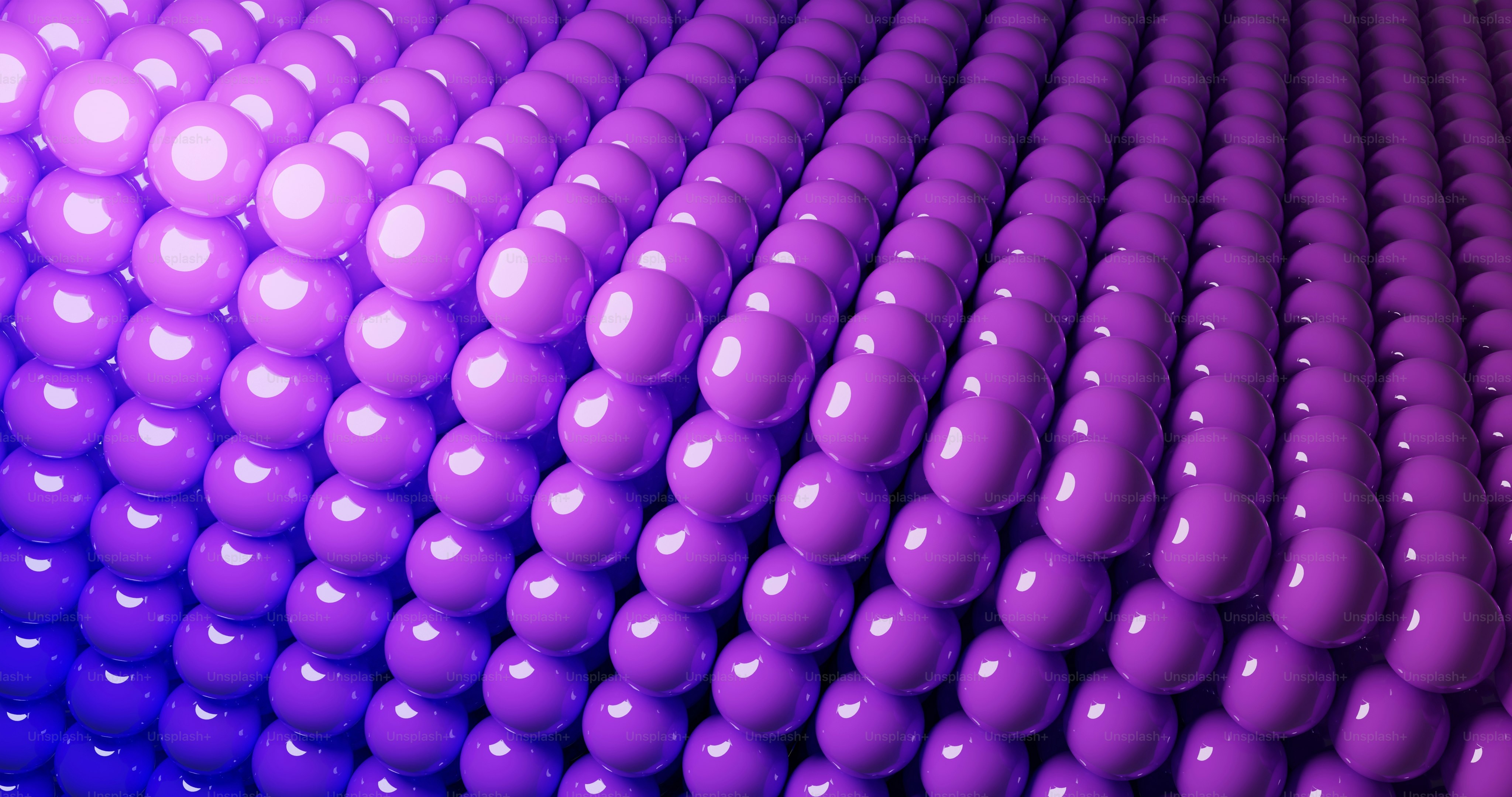 a large group of purple balls in a room