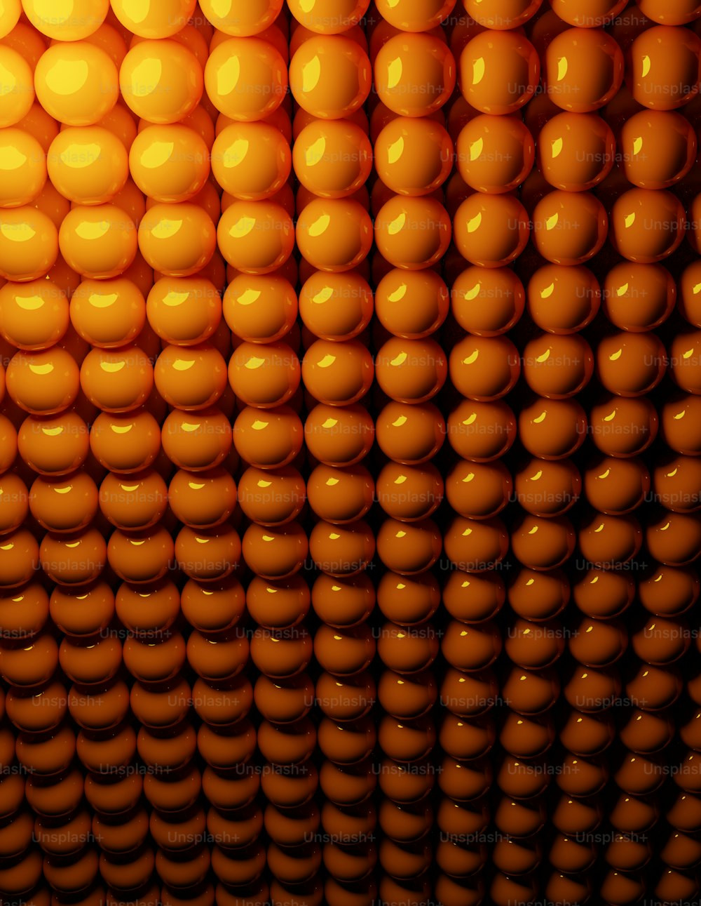 a wall made up of orange balls in a room