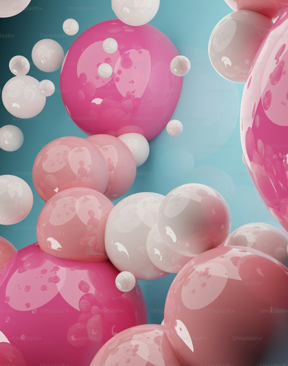 a bunch of pink and white balloons floating in the air