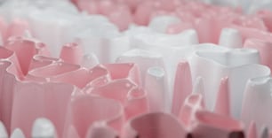 a group of white and pink vases sitting next to each other