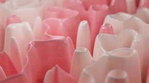 a group of pink vases sitting next to each other