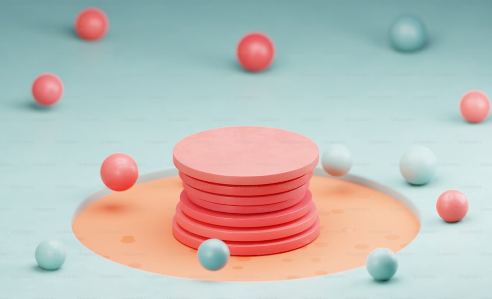 a stack of pink and blue balls on a blue surface