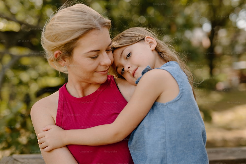 a woman holding a little girl in her arms