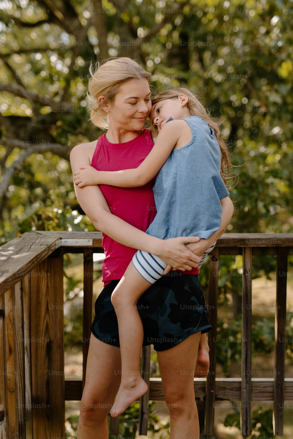 a woman holding a little girl on her back