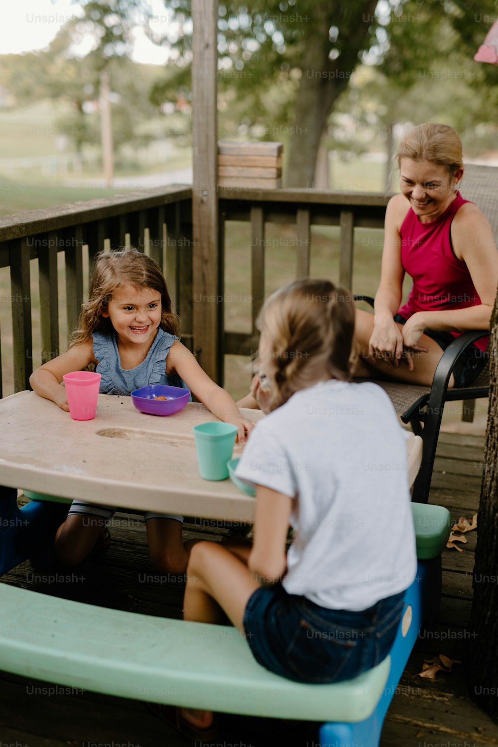 a group of children sitting around a table