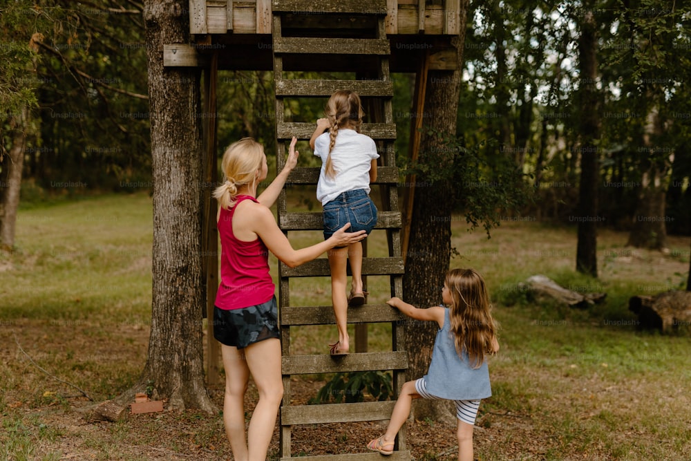 a group of girls climbing up a wooden ladder