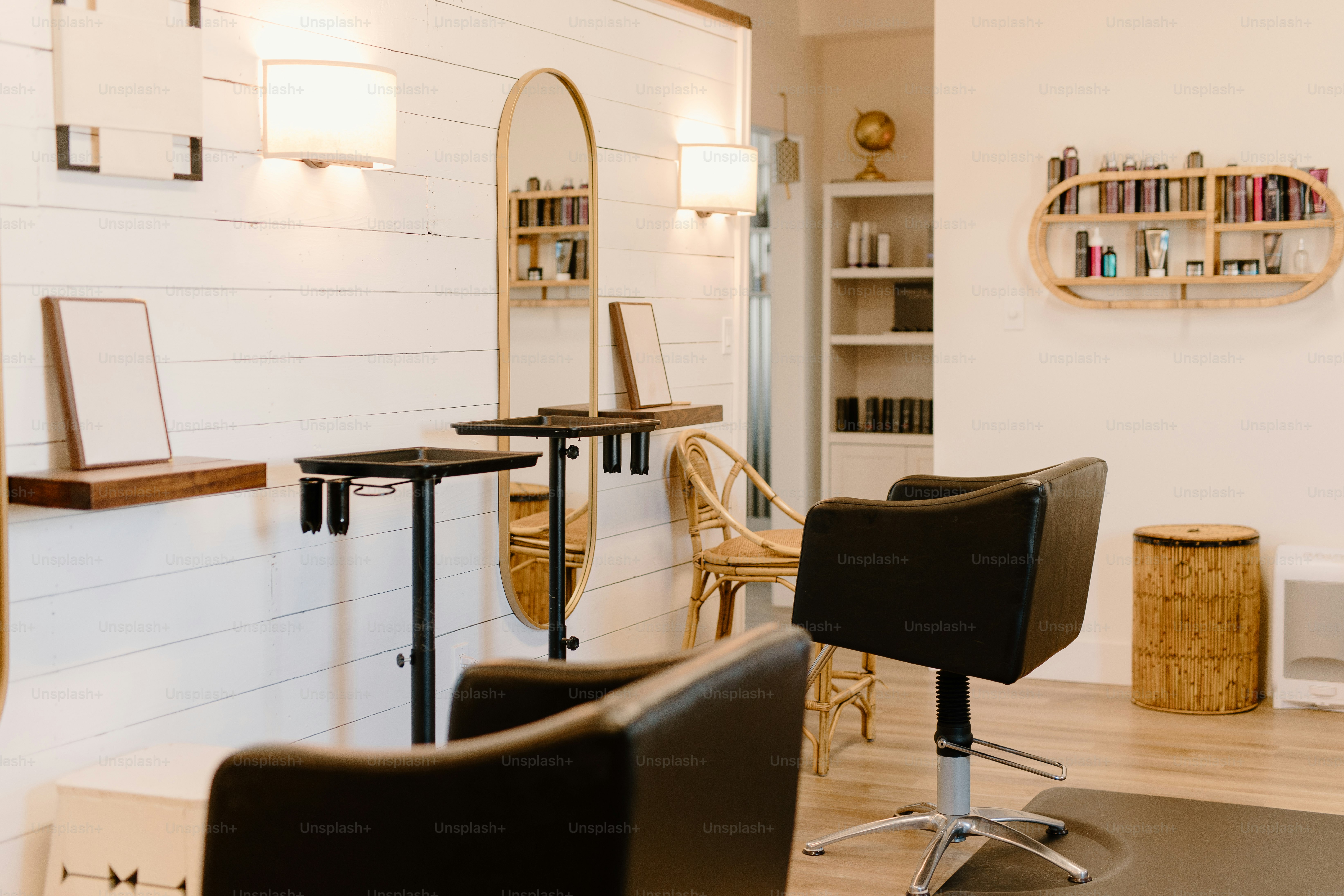 a hair salon with chairs and a mirror