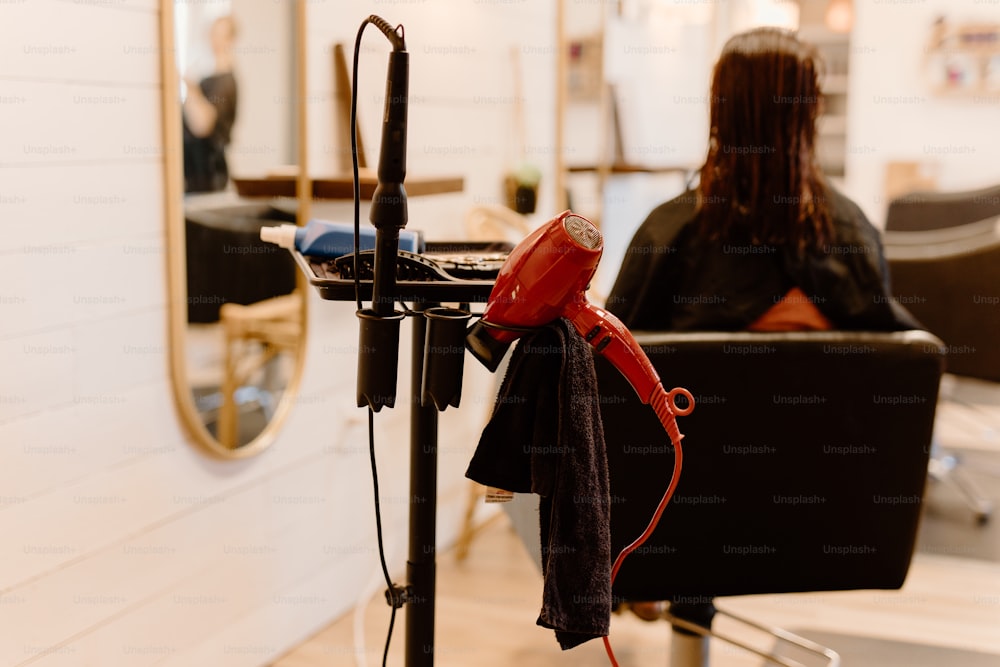 a woman blow drying her hair in a salon