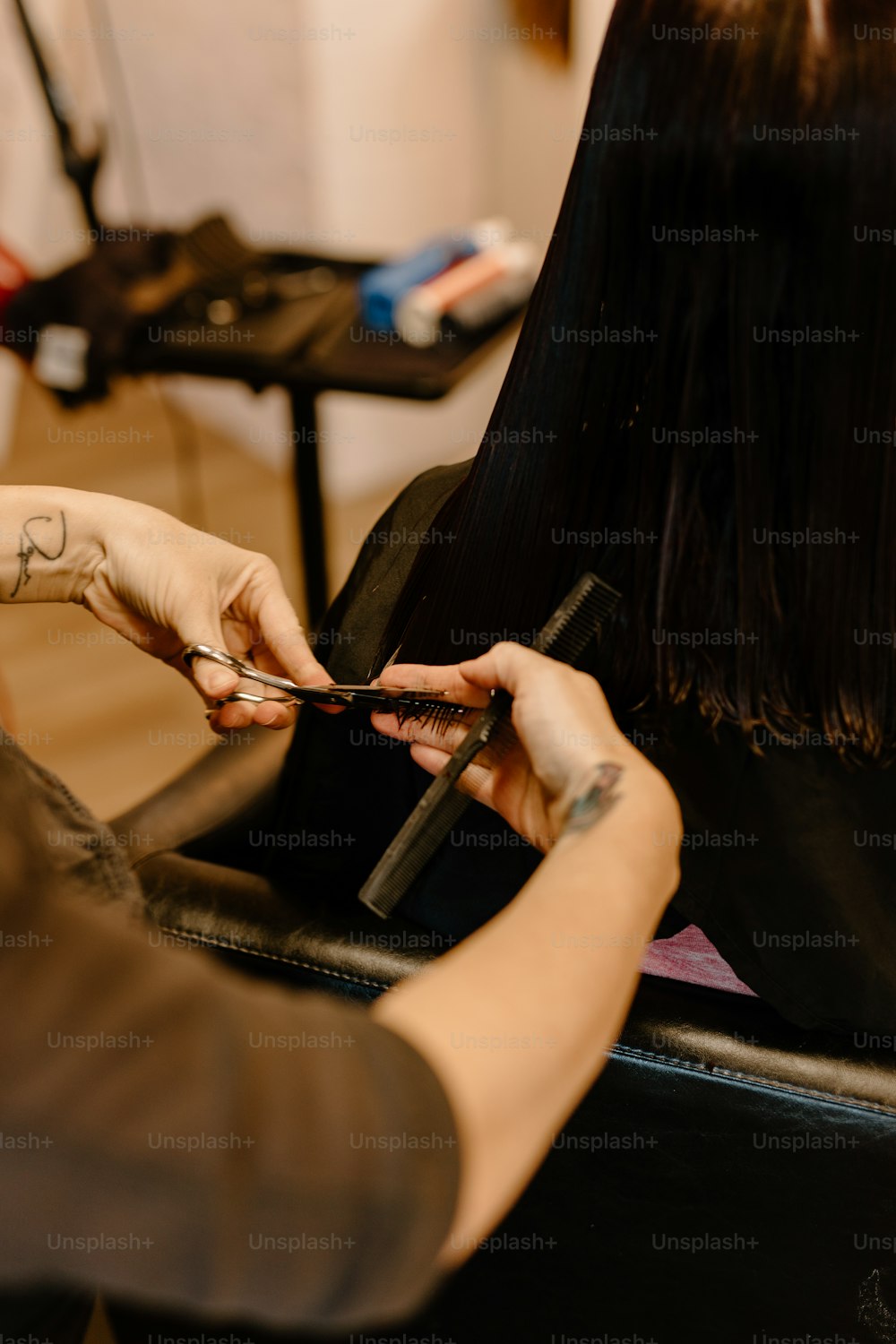 a woman cutting another woman's hair with scissors