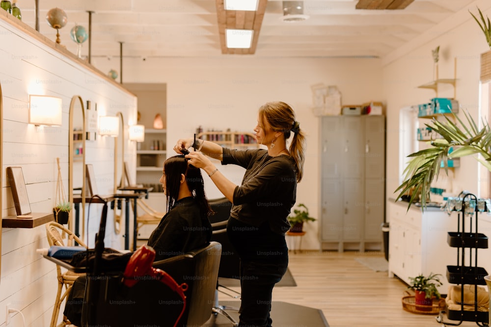 a woman getting her hair cut in a salon