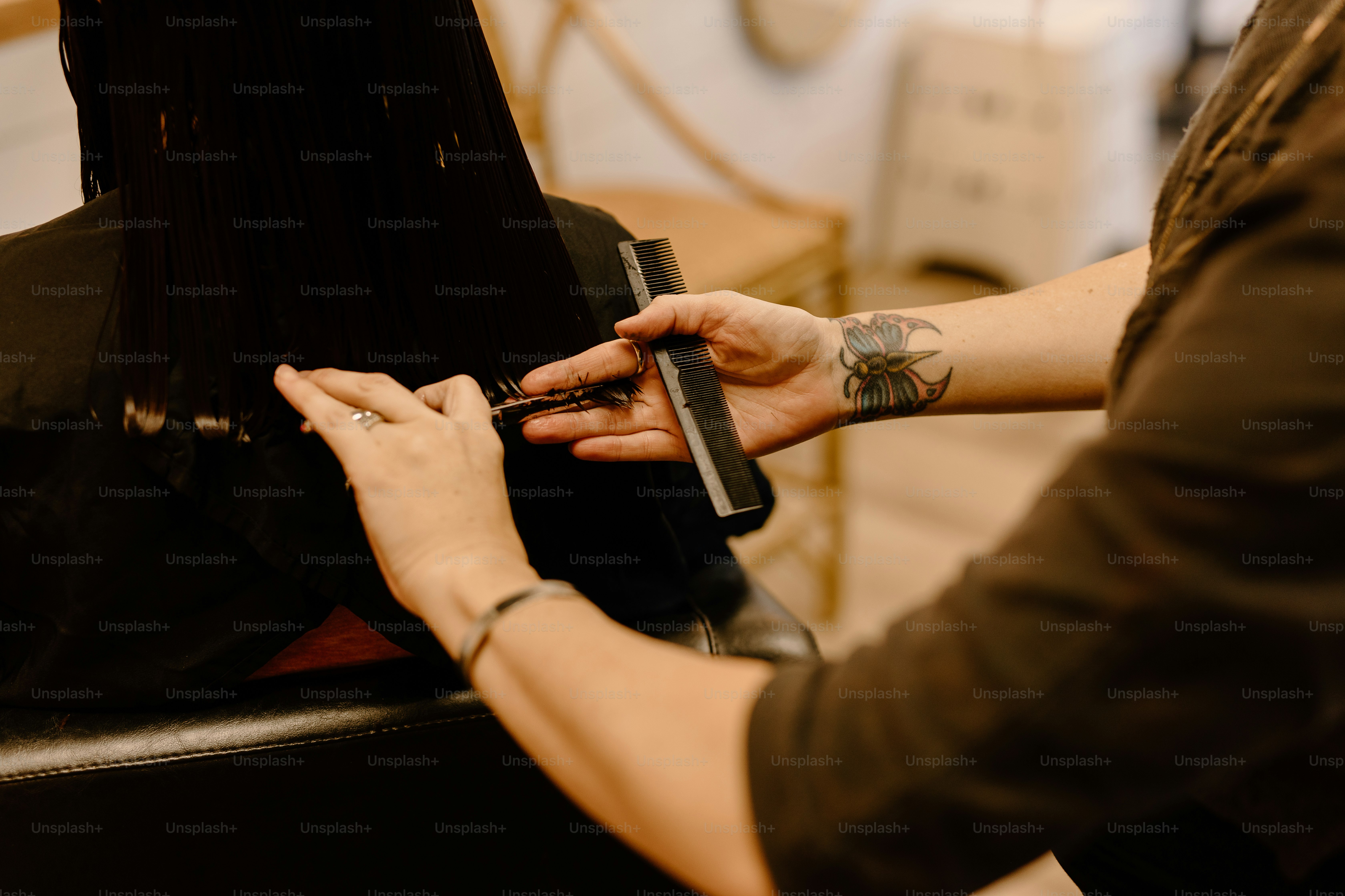 a woman getting her hair cut by a hair stylist