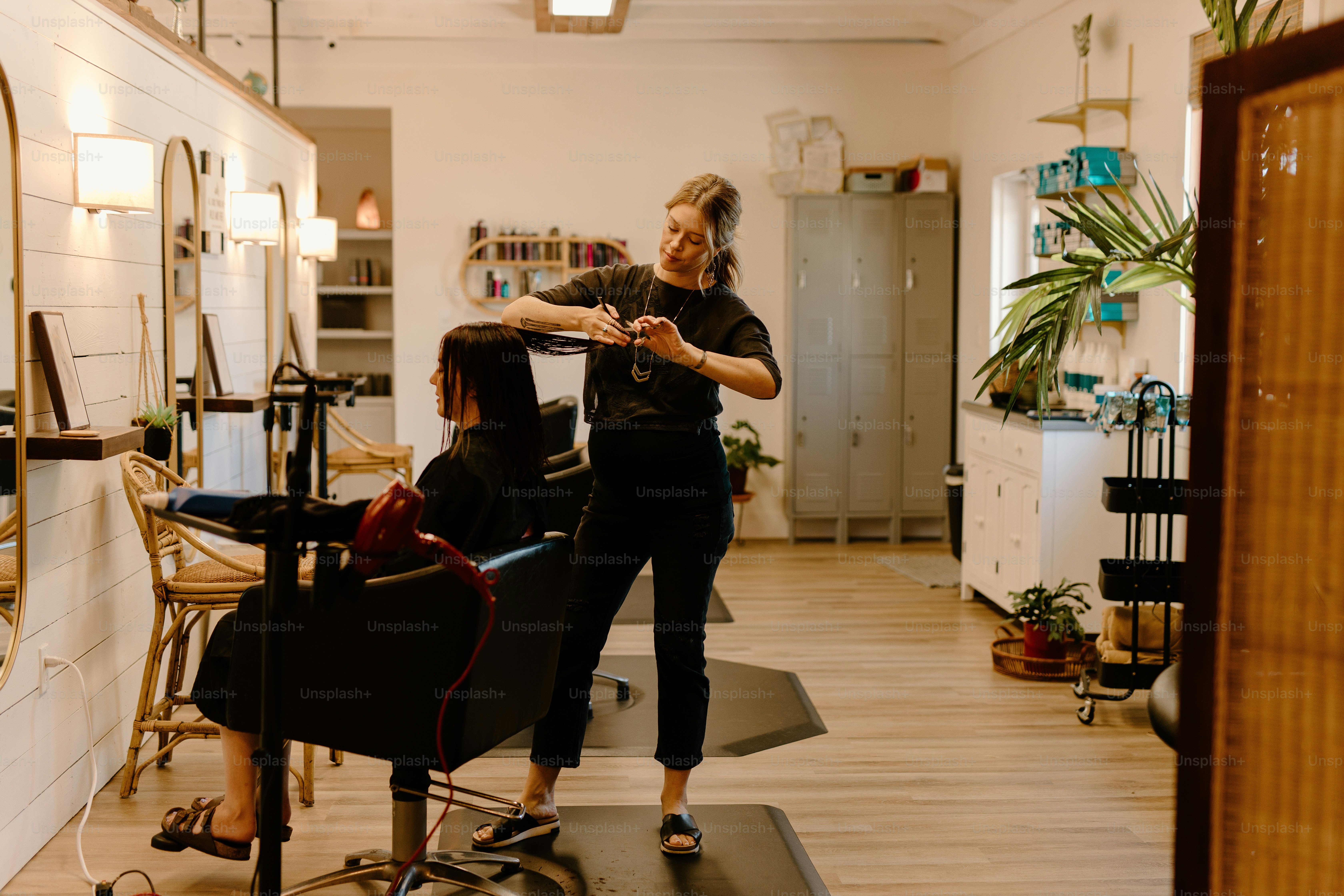 a woman getting her hair cut in a salon