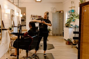 a woman getting her hair cut in a salon