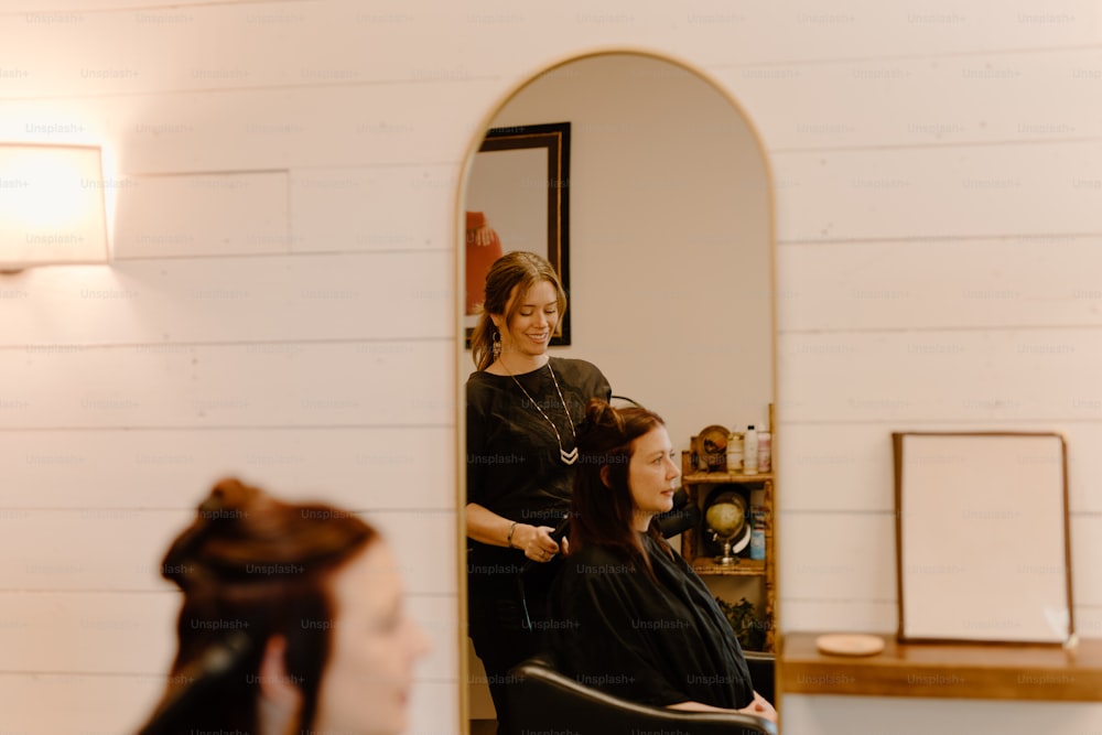 a woman getting her hair cut in a salon