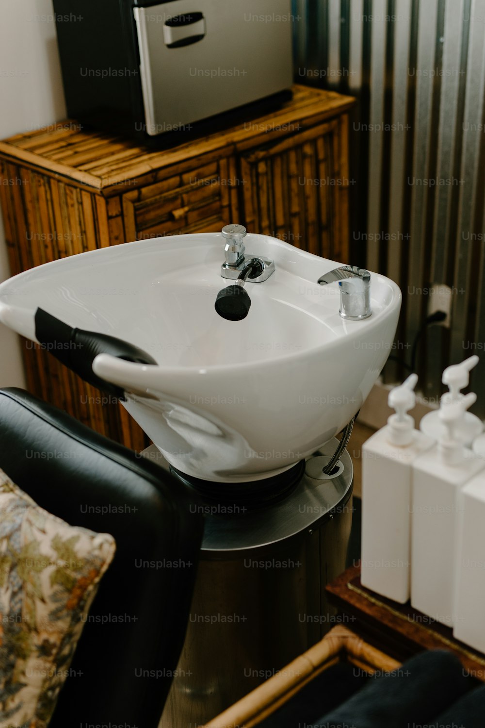a white sink sitting on top of a black chair