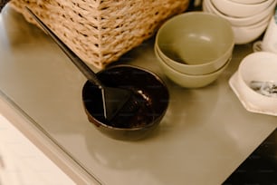 a table with a basket, bowl, and spoon on it