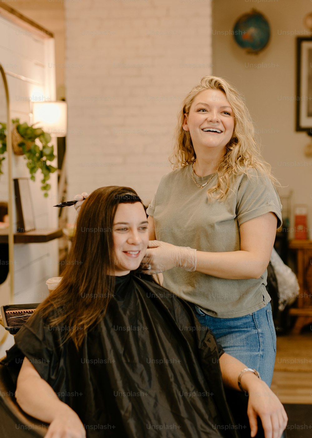 a woman sitting in a chair getting her hair cut