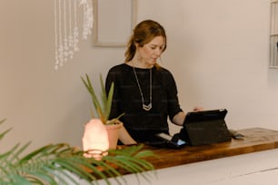 a woman sitting at a desk using a laptop computer