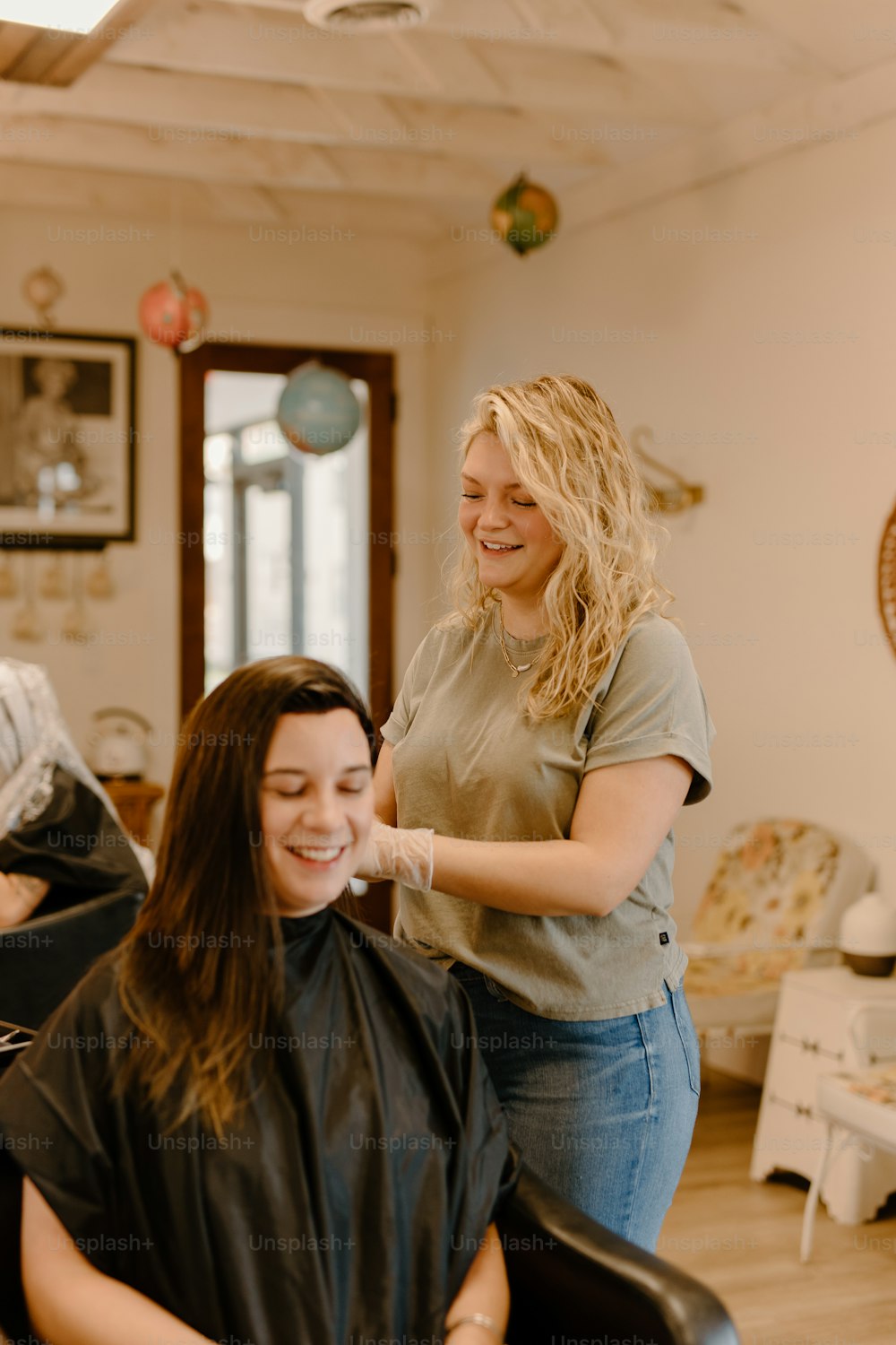 a woman getting her hair cut in a salon