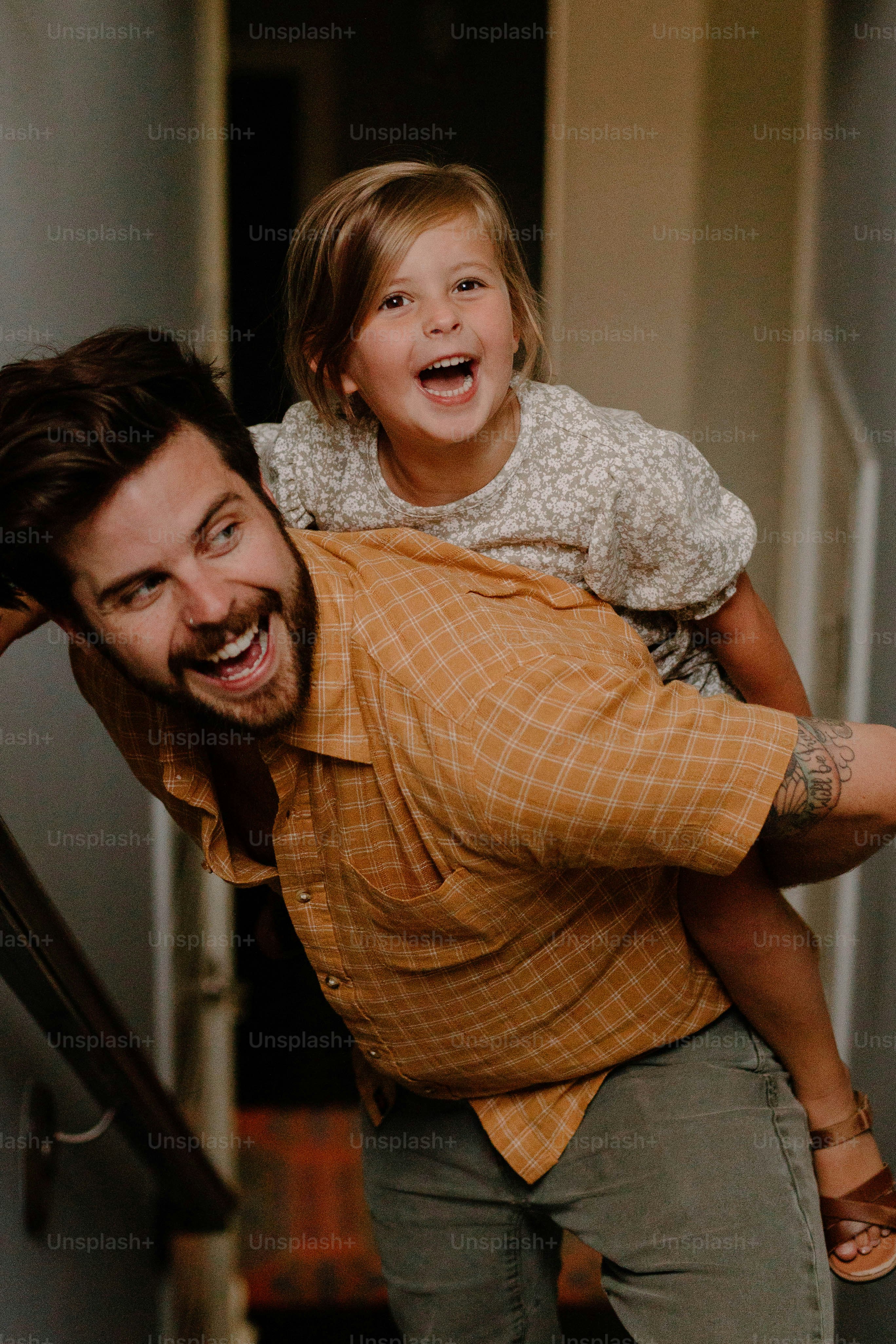 a man carrying a little girl on his back