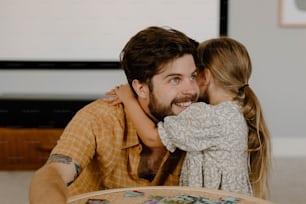 a man and a little girl hugging each other