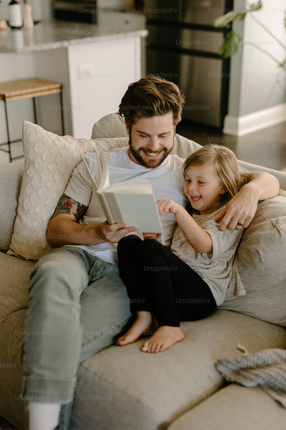 a man and a little girl sitting on a couch