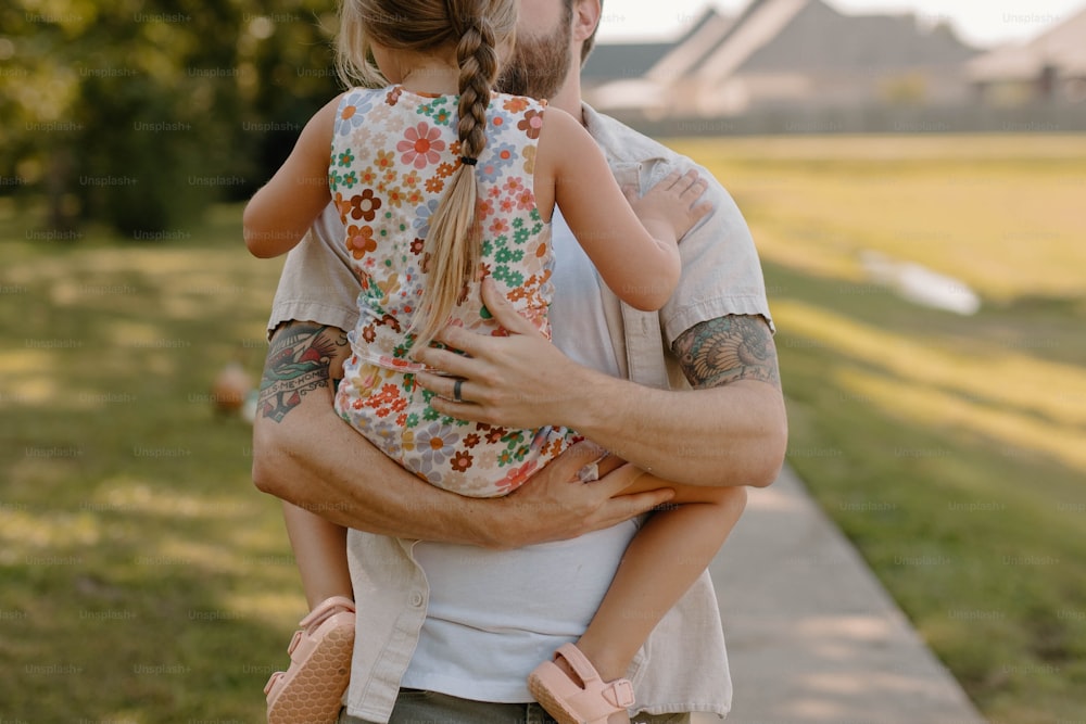 a man holding a little girl in his arms