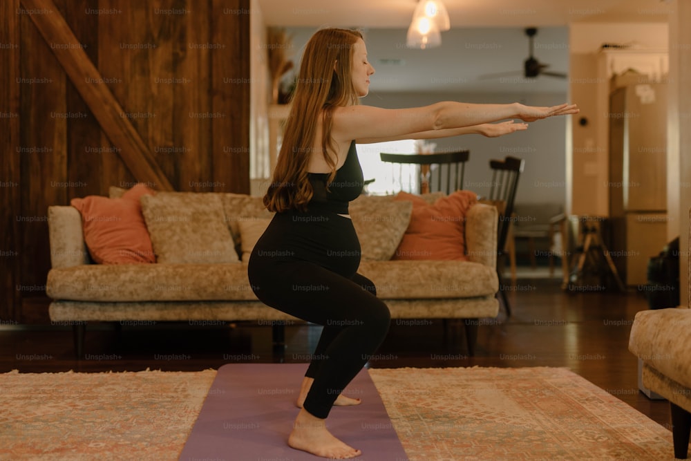 a woman doing a yoga pose in a living room