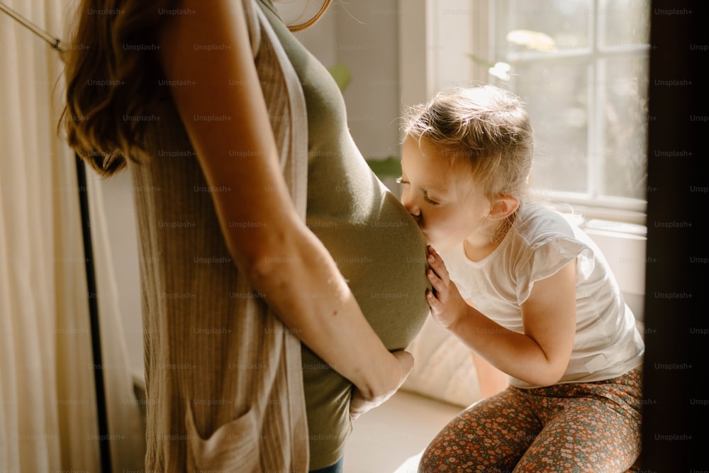 a woman is holding a baby in her lap