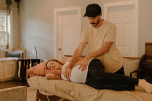 a man standing over a woman laying on a bed